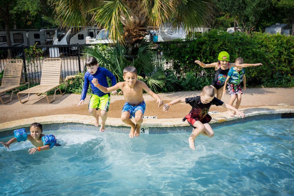 kids jumping into the pool