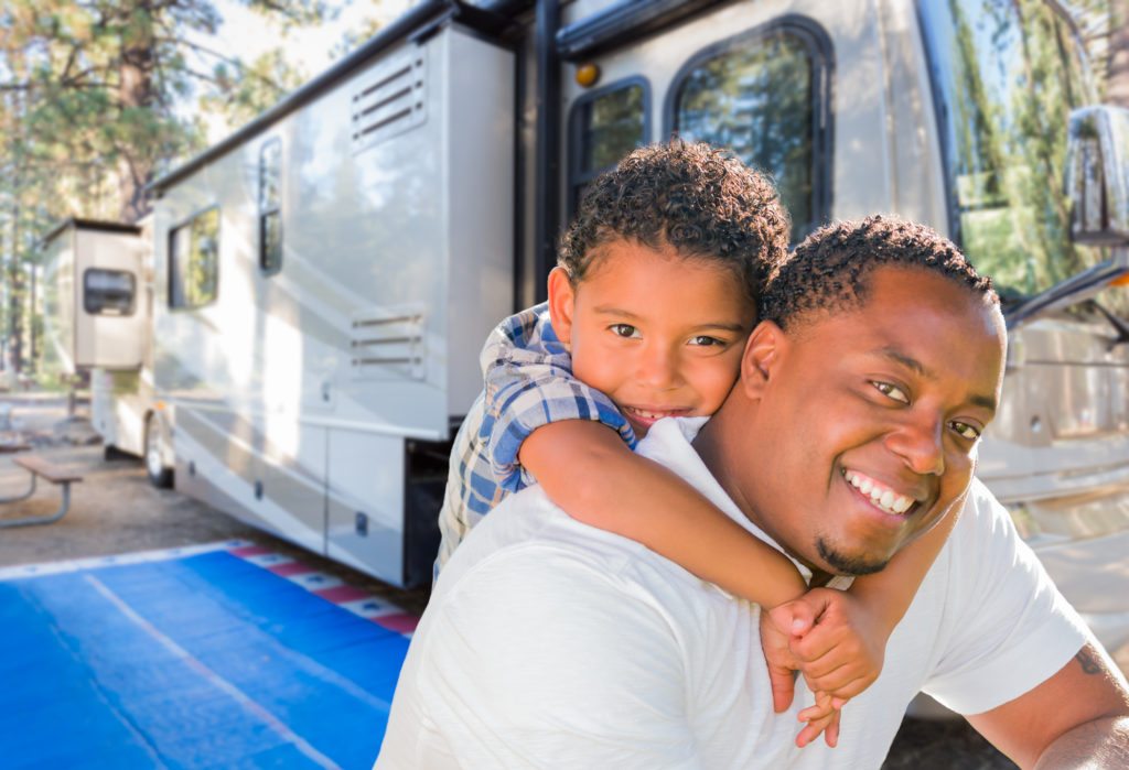 family in front of rv