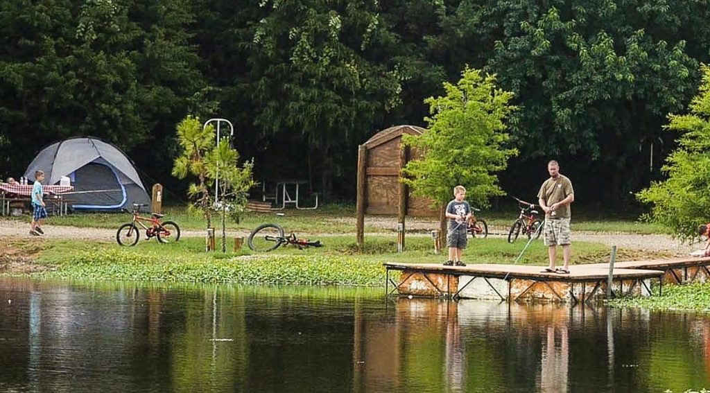 father and son fishing on lake